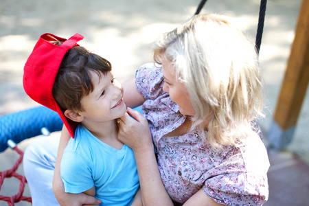 Mother playing with son in park, outdoor portaitの写真素材