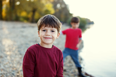 Little brothers portrait at river, outdoor, childhoodの写真素材
