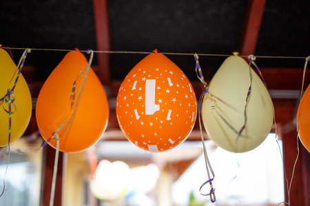 Colorful party balloons hanging outdoorの写真素材