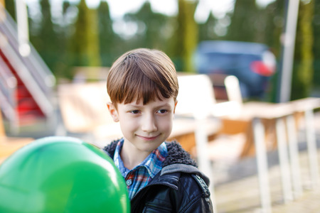 Little boy with green balloon, outdoor portraitの写真素材
