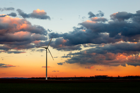 Wind power plant in sunset