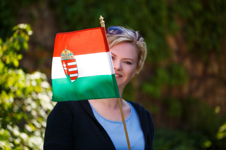 Blonde woman with Hungarian flag outdoor portrait