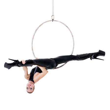 Sexy woman performance in latex catsuit on aerial hoop isolated on whiteの写真素材