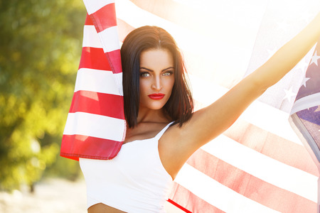 Sexy woman with usa flag outdoor star spangled banner 4th july independence dayの写真素材