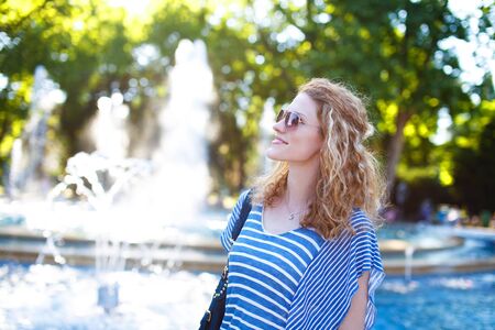 Redhead woman tourist in park outdoor portraitの写真素材