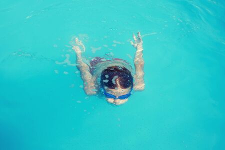 Little boy diving in water, underwater trainingの写真素材