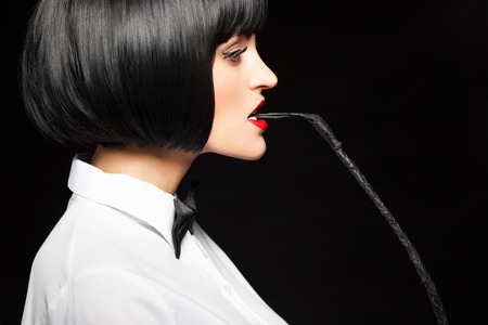 Sexy woman in wig bite whip, bdsmの写真素材