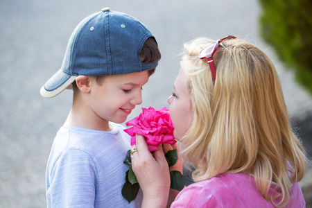 Happy little boy give rose to mom, mother's dayの写真素材