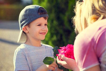 Happy little boy give flower to mom vintage, mother's day, motherhoodの写真素材