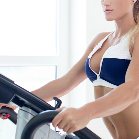 Blonde woman on treadmill in gym, weght lossの写真素材
