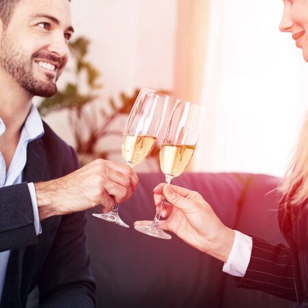 Businessman toast with businesswoman in office closeupの写真素材