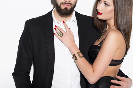 Sexy rich couple posing at white wall closeupの写真素材