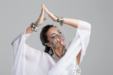 Sensual oriental dancer woman portrait with gems and veilの写真素材