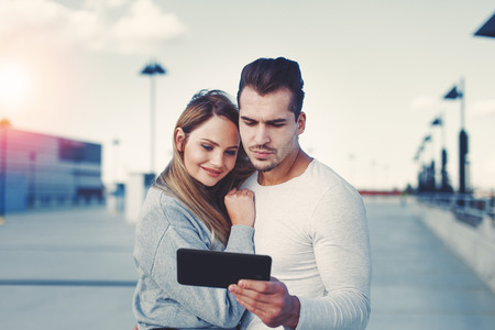 Young smart businesswoman holding tablet and eyeglasses cinematic style