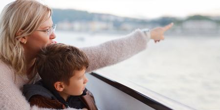 Mother showing away to son, pointing to distanceの写真素材