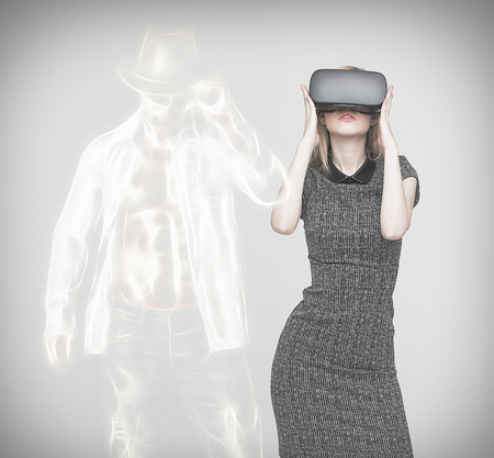 Young blonde woman with VR showing sexy dancer cowboy manの写真素材