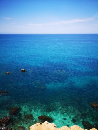 Rocky mediterranean seashore with azure and turquoise color water, Malta, EUの写真素材