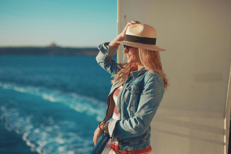 Excited young traveler woman on cruise ship waiting for docking, summer holidayの写真素材