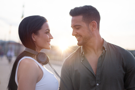 Young couple dating in city sunset portrait, life balance and happinessの写真素材