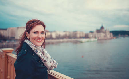 Redhead urban young beauty woman posing at Budapest panorama in cold weather, Hungaryの写真素材
