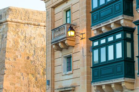 Green traditional maltese balconies with lamp, Valletta, Maltaの写真素材