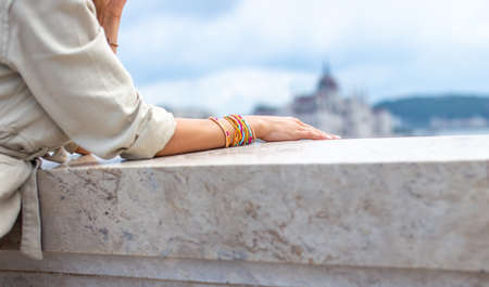 Young woman elbowing on stone railing in city, outdoors, Budapest, Hungary