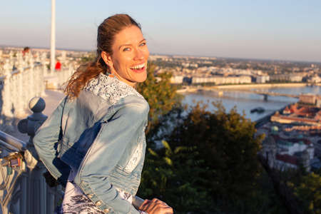 Young woman wondering in Budapest panorama, back view, Hungary