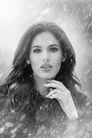 Sensual woman in snowfall black and white portrait, book cover templateの写真素材