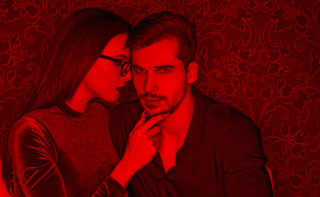 Young sexy man seducing smart girl in clubの写真素材