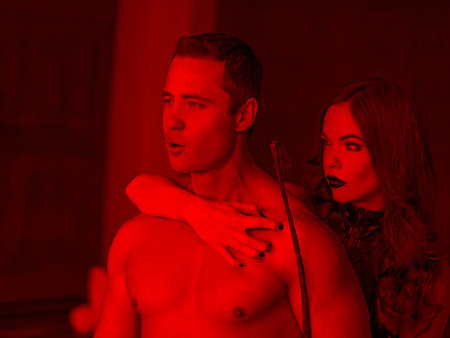 Sexy naked macho man enjoying moment with dominatrix in red light, bdsmの写真素材