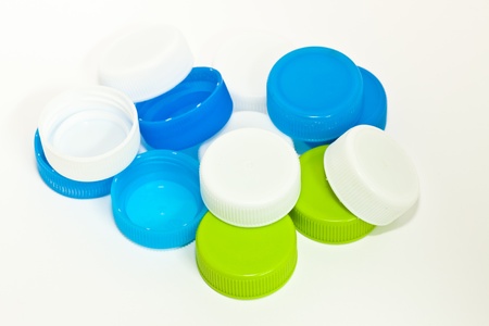 Pile of bottle caps.Bottle of white, green and blue.