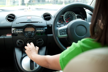 asian woman driving the car. View from back seats of the car.の写真素材