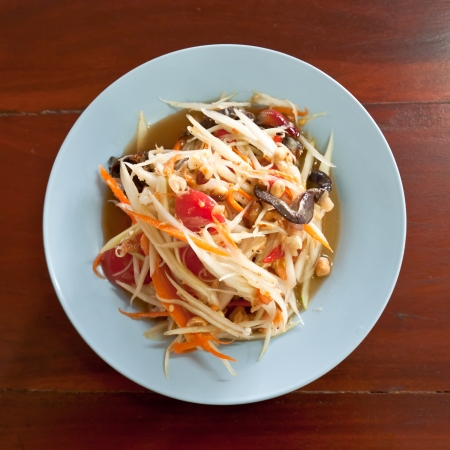 Thai papaya salad hot and spicy mixed from variety of vegetable on wood tableの写真素材