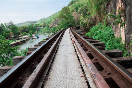 Death railway against the cliff and the river in Kanchanaburi Thailandの写真素材