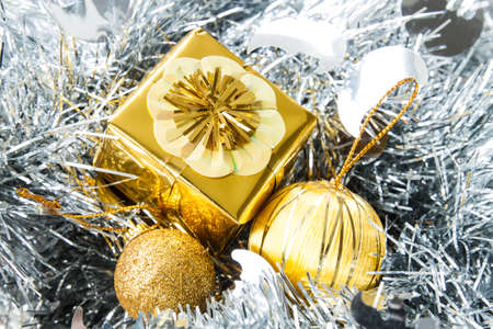 Christmas background with a golden gift boxの写真素材