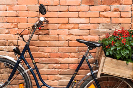 flower in the vase on a bicycle with brick wall backgroundの写真素材