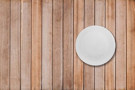 white dishes on a wooden tableの写真素材