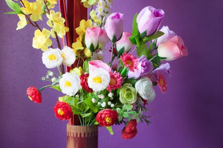 Close up bouquet of  artificial flowers with wallの写真素材