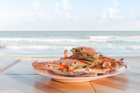 Steamed crab in plate with sea backgroundの写真素材