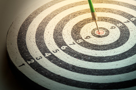 dart arrow hitting in the target center of dartboard,abstract of successの写真素材