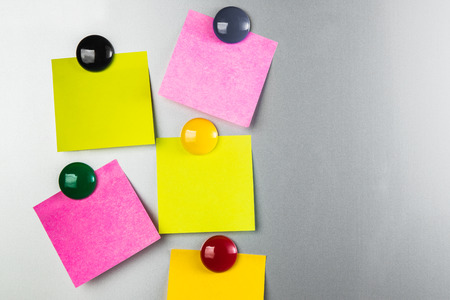 blank Sticky  note and magnet on refrigerator , five paper sheet background.の写真素材