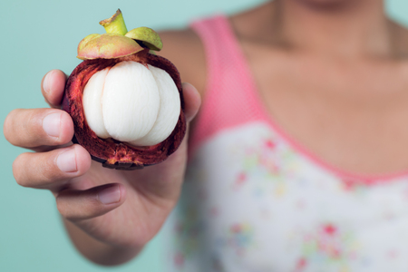 asian girl holding mangosteen, tropical fruit,healthy eating, dieting concept , 
vegetarian food.の写真素材