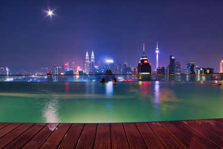 Kuala Lumpur, Malaysia - April 20, 2019 : Enjoying my swimming at the private pool on the rooftop with stunning cityscape, Kuala Lumpurのeditorial素材