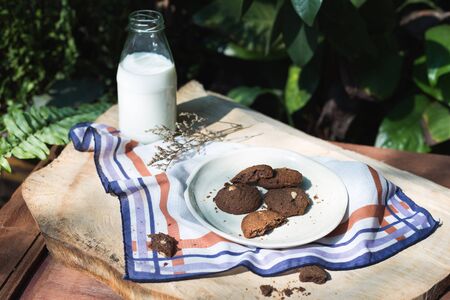 cookies on a plate and milk on wood.の写真素材