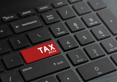 Computer keyboard with tax keys in 2022 to start this. and tax deducted from income and expenses in the year 2022の写真素材