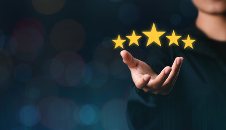 The customer's hand or the customer holds a star to complete five stars. with copy space five star...