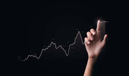 businessman hand pointing to success in growth graph metaverse technology financial business chart financial chart technology investment in stock market background analysis digital economy exchangeの写真素材