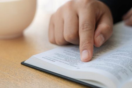 A young Christian woman sits at home reading and studying the Bible on Sunday. with the doctrine of...