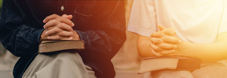 young couples praying to god together and study the Bible together to serve Godの写真素材