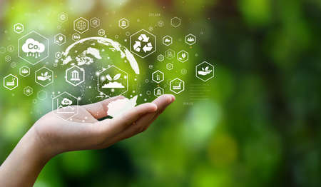 Environmental energy reduction concept. CO2 emissions with global warming icons. with business men typing computersの写真素材